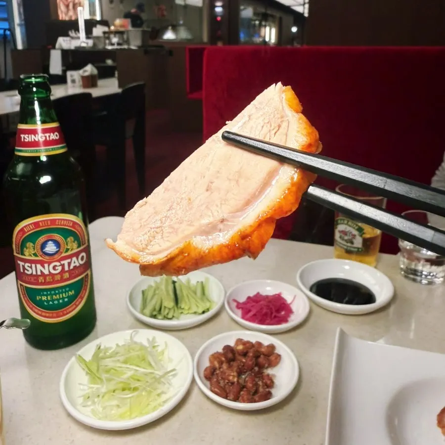 Peking duck and vegetables piled on a pancake
