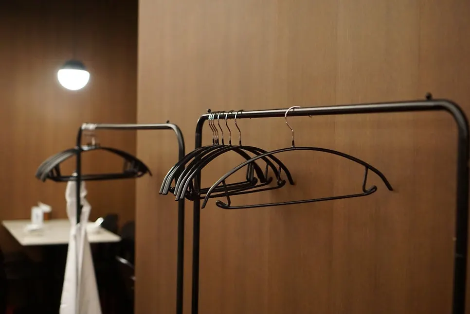 Coat hangers and table seating in a corner of the restaurant