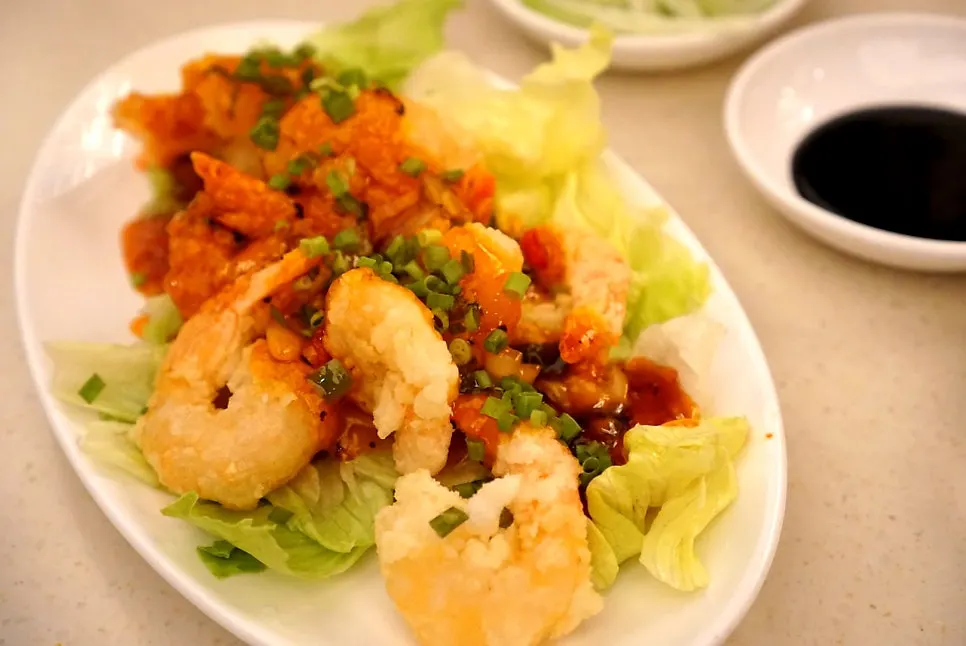 A plate of kkanpung shrimp drizzled with sauce