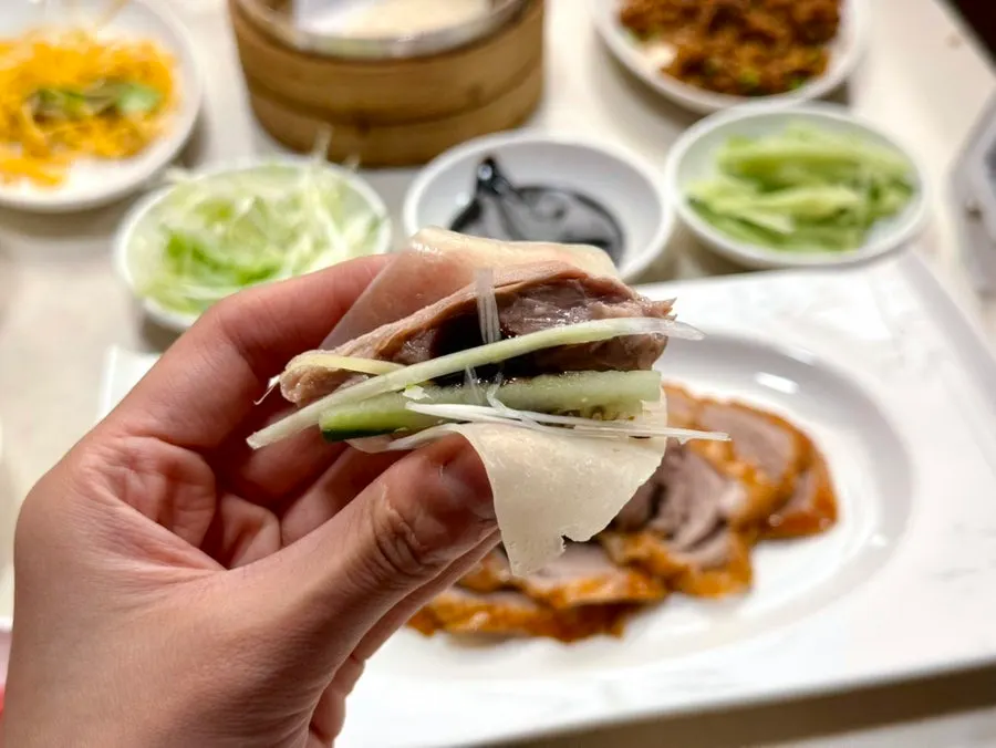 Warm Peking duck pancakes separated by paper
