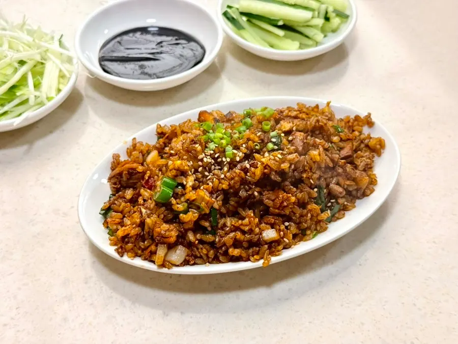 Peking duck wrapped in a pancake with scallion strips and cucumber