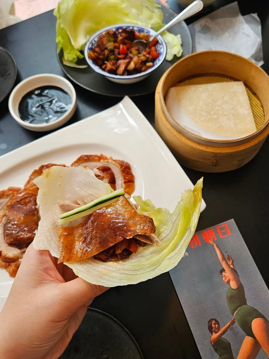 Duck placed on a ya-mil-byeong pancake for wrapping