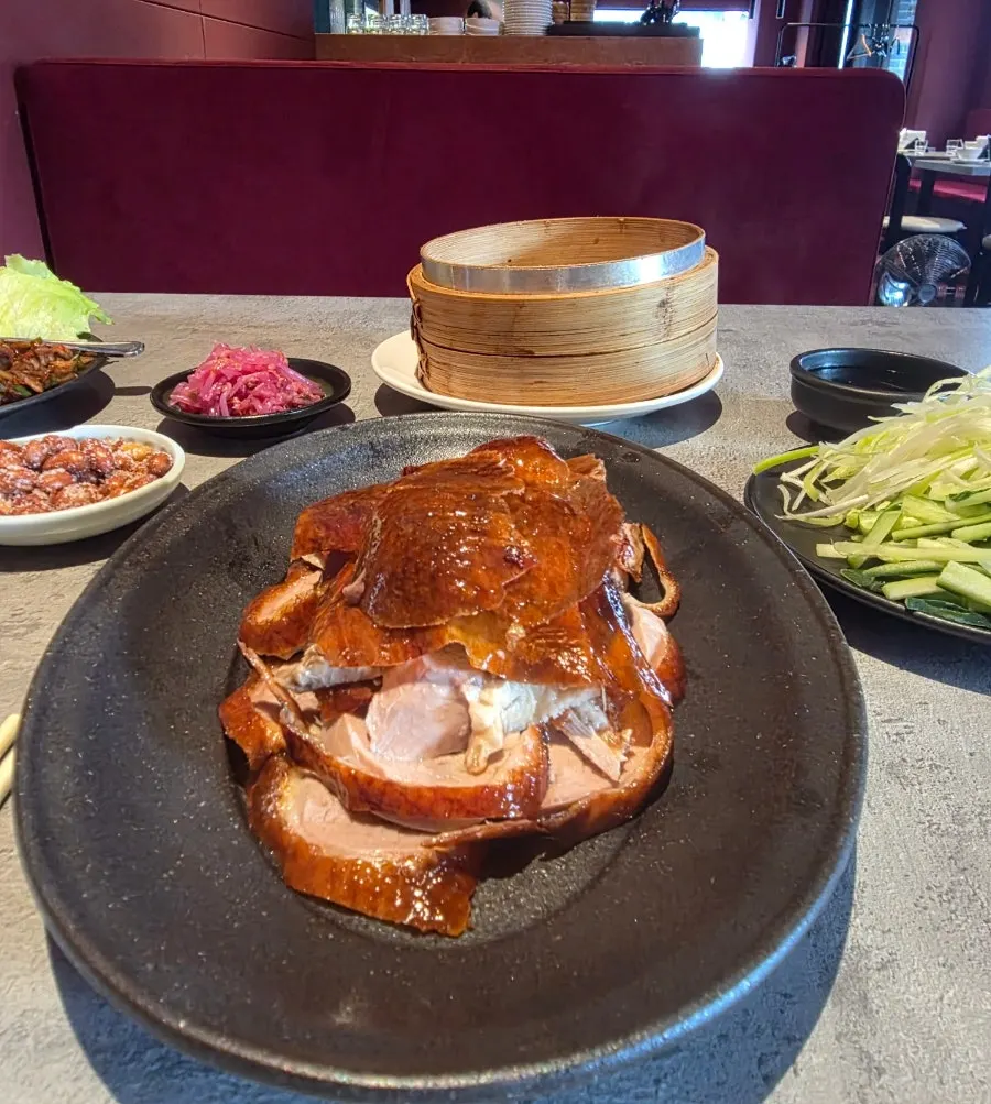 검은 접시에 담긴 북경오리 반 마리