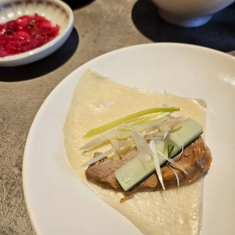 Duck skin and meat placed on a wheat pancake