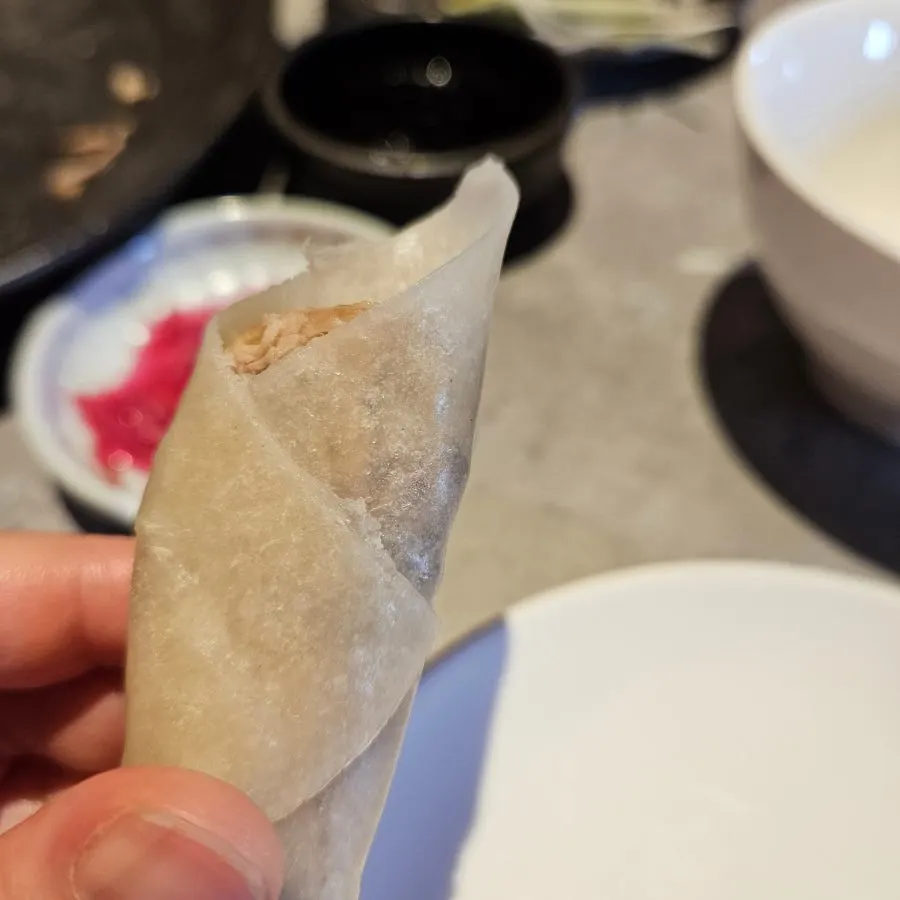 A finished bite of wrapped Peking duck