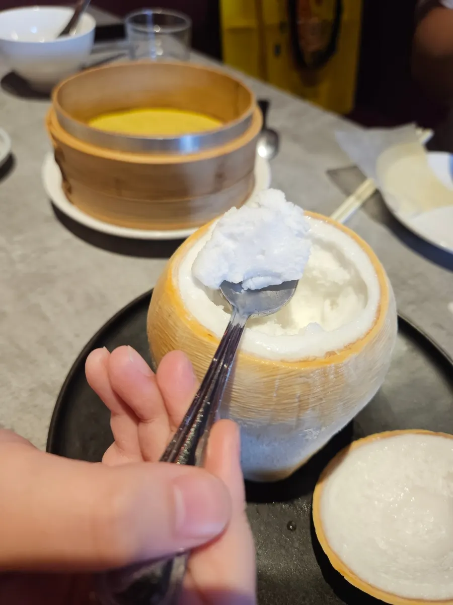 A spoonful of ice cream with chewy coconut bits