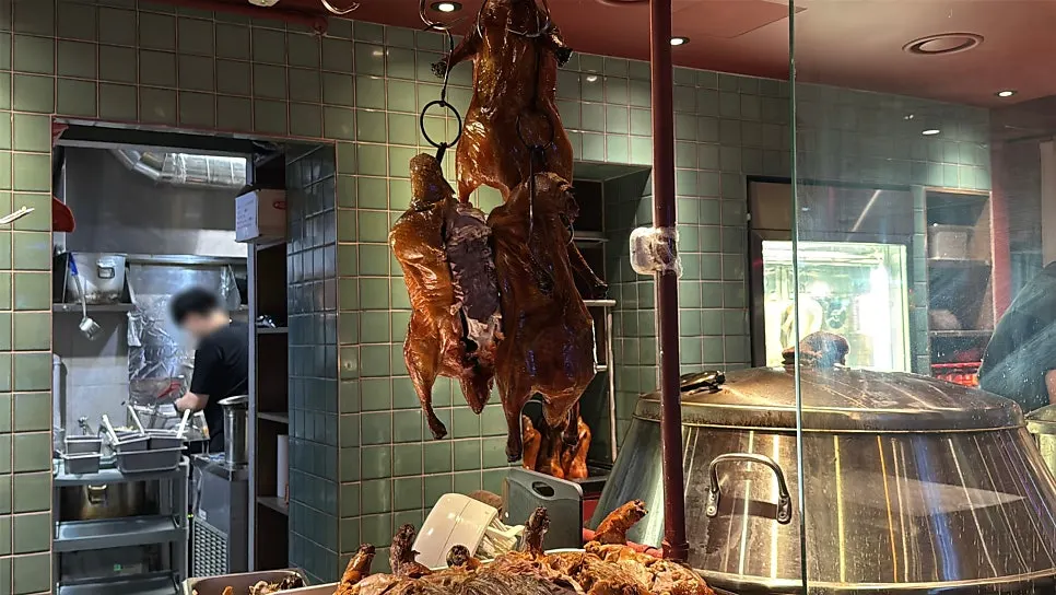 Peking ducks hanging at the entrance