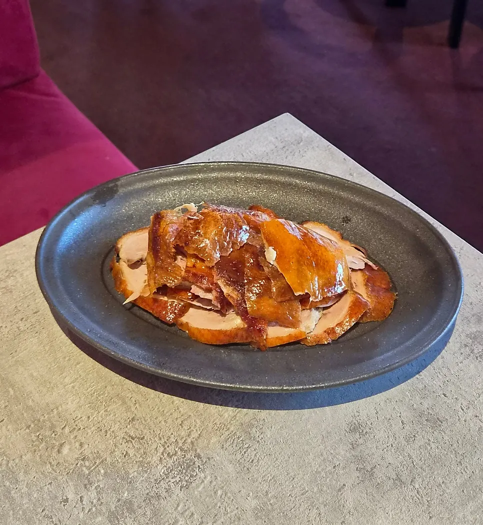 A half order of Peking duck on a plate