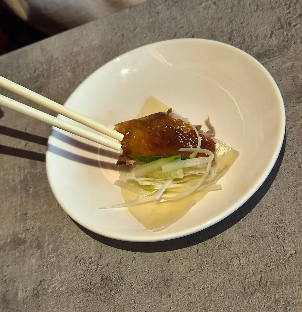 Duck meat and vegetables piled onto a wheat pancake