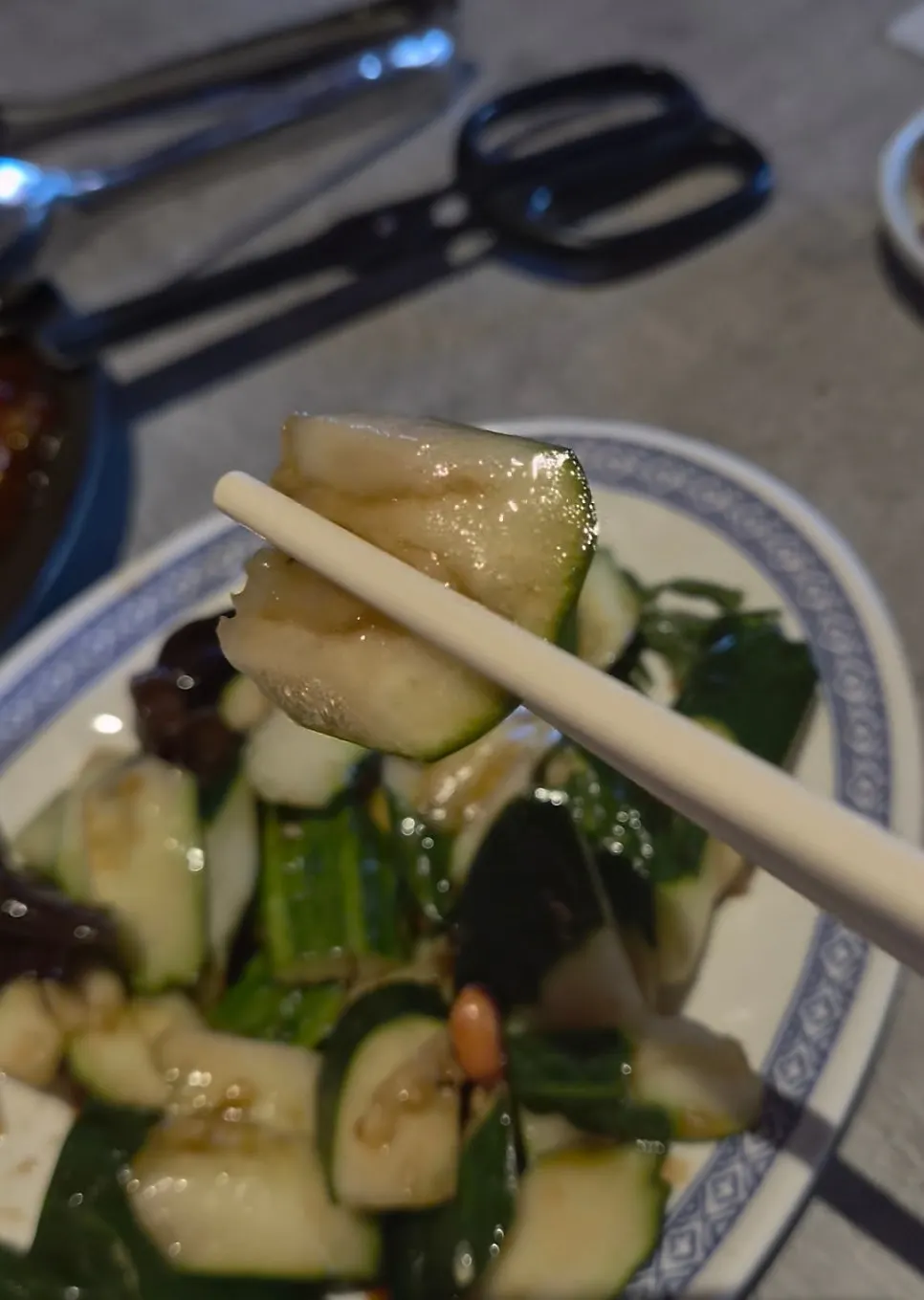 Picking up cucumber and wood ear mushroom with chopsticks