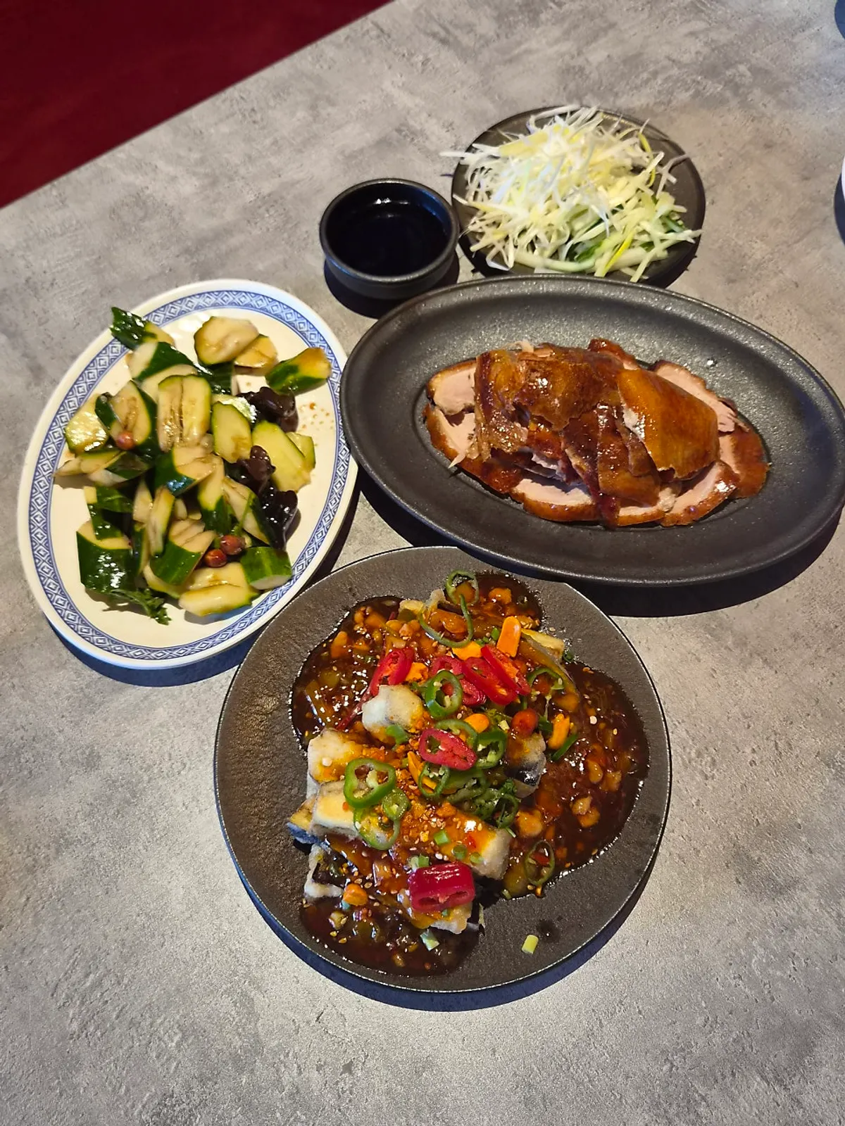 Peking duck and eggplant fritters set together on the table