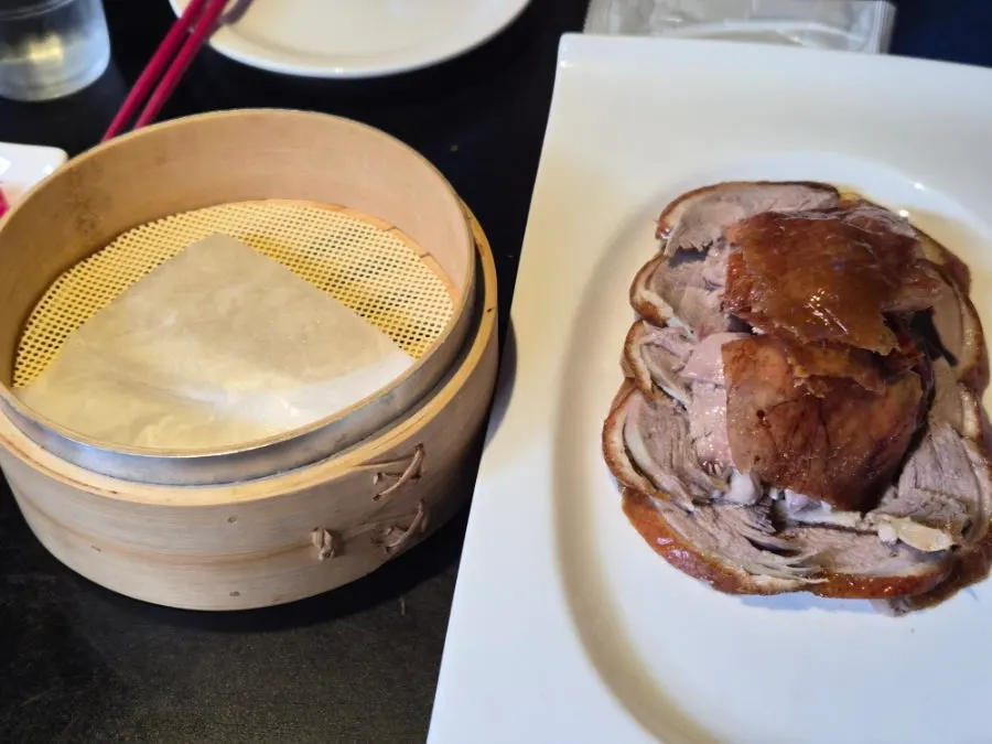 Half Peking duck served with cucumber, scallion strips, and wheat pancakes