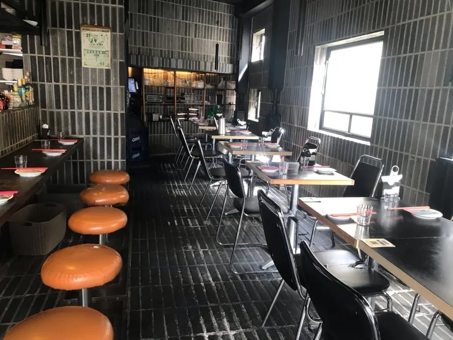 Hall with black tables and chairs