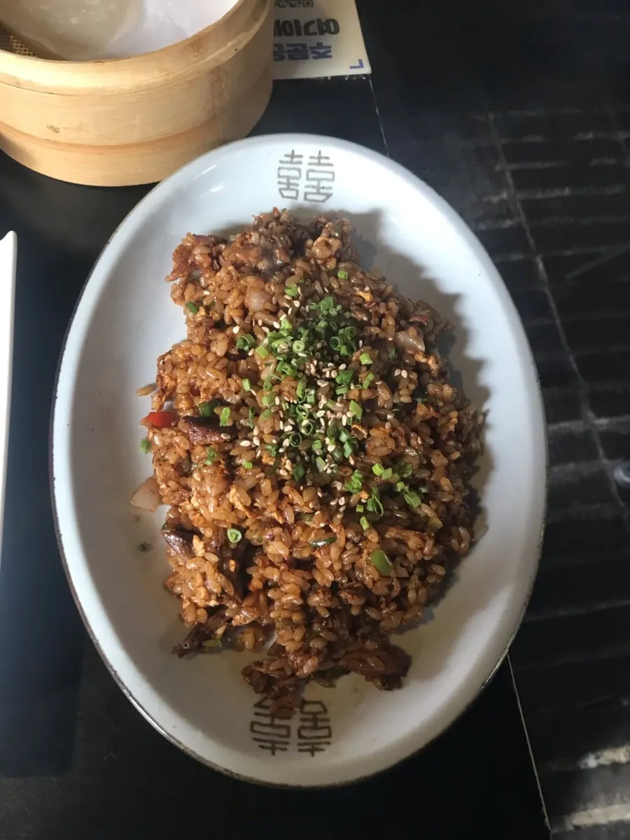 A bowl of fried rice with meat