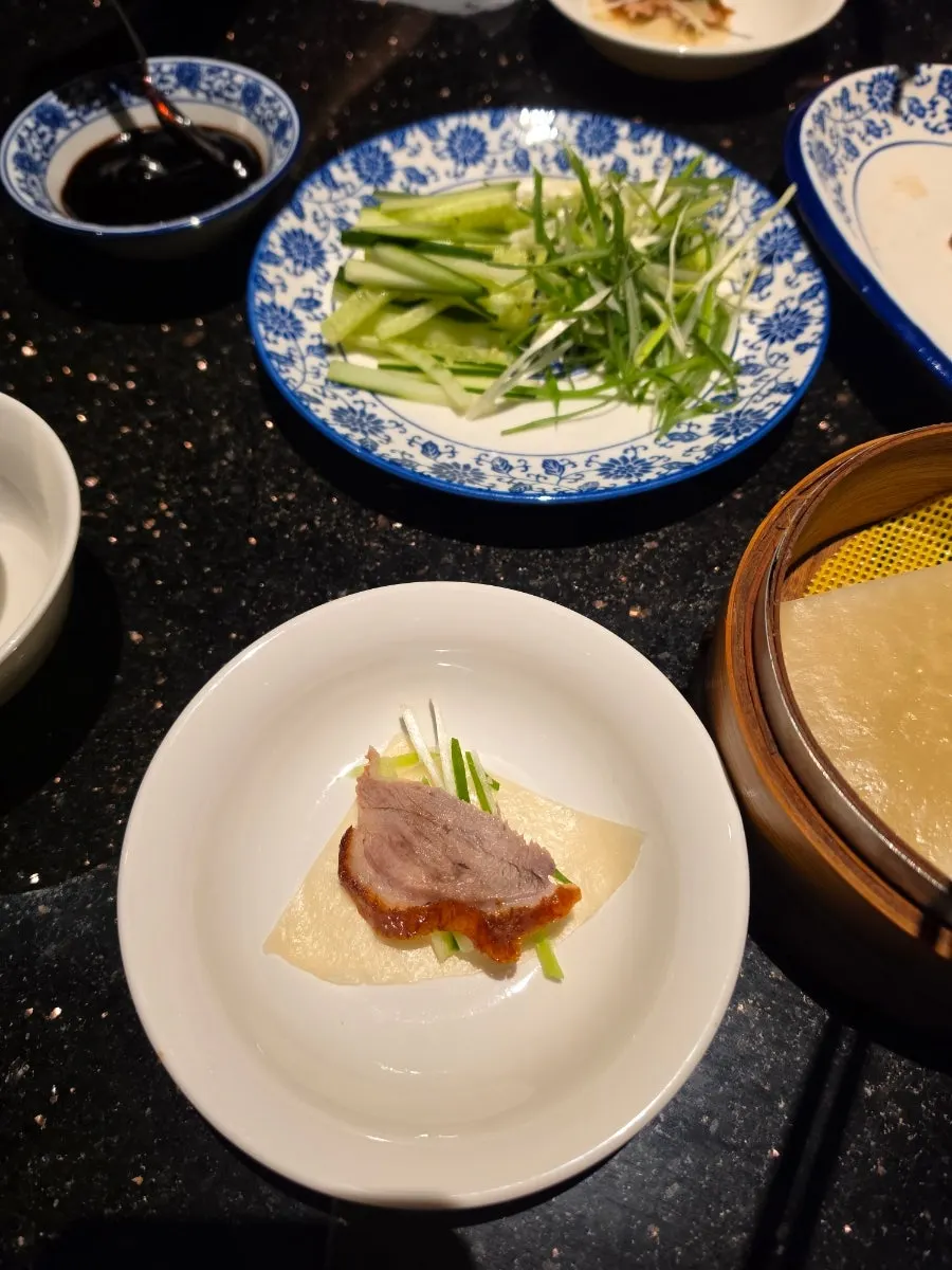 Peking duck wrap topped with sauce