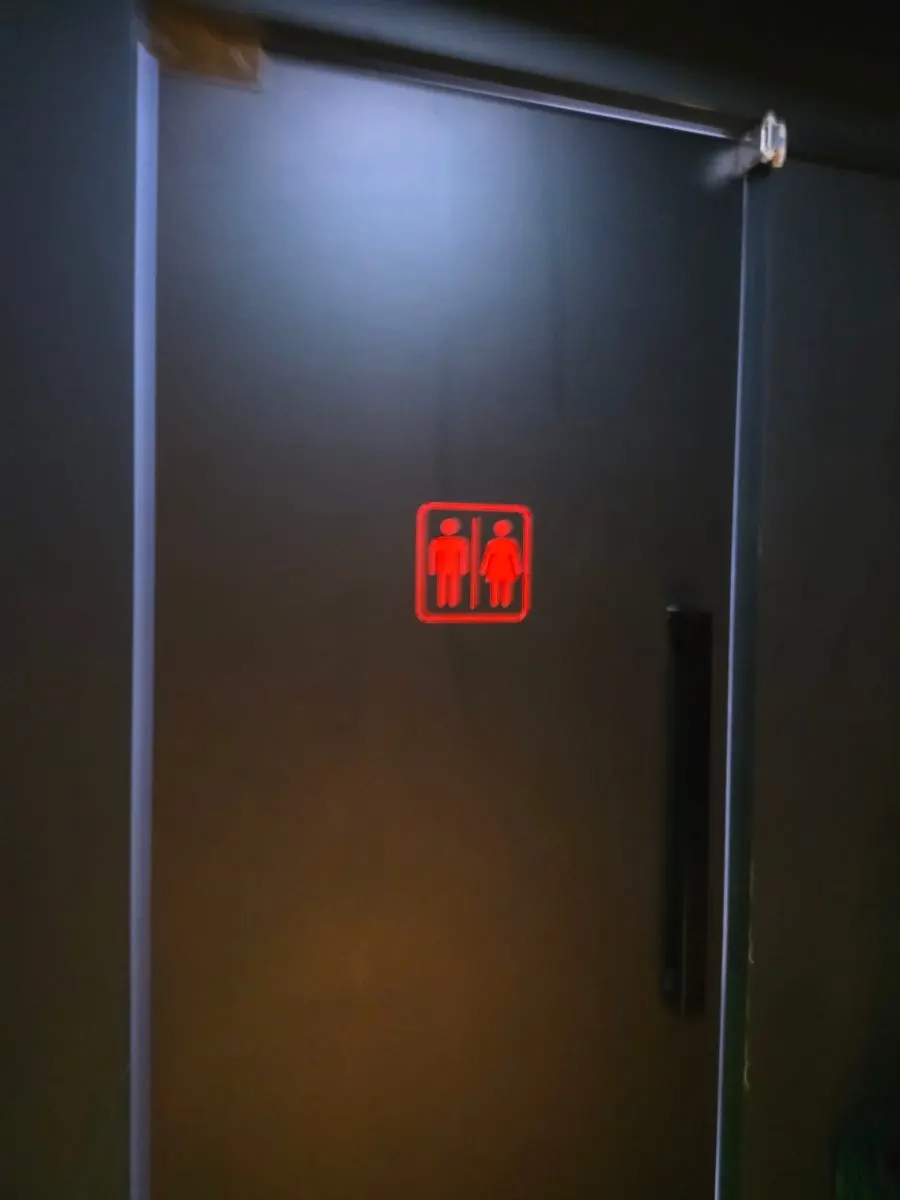 Restroom sign near the emergency exit