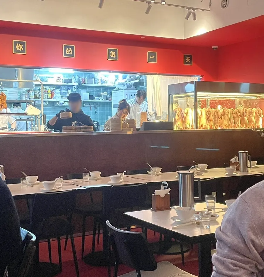 Interior of Mirim Yangjang Seolleung Branch with red lighting and red tables