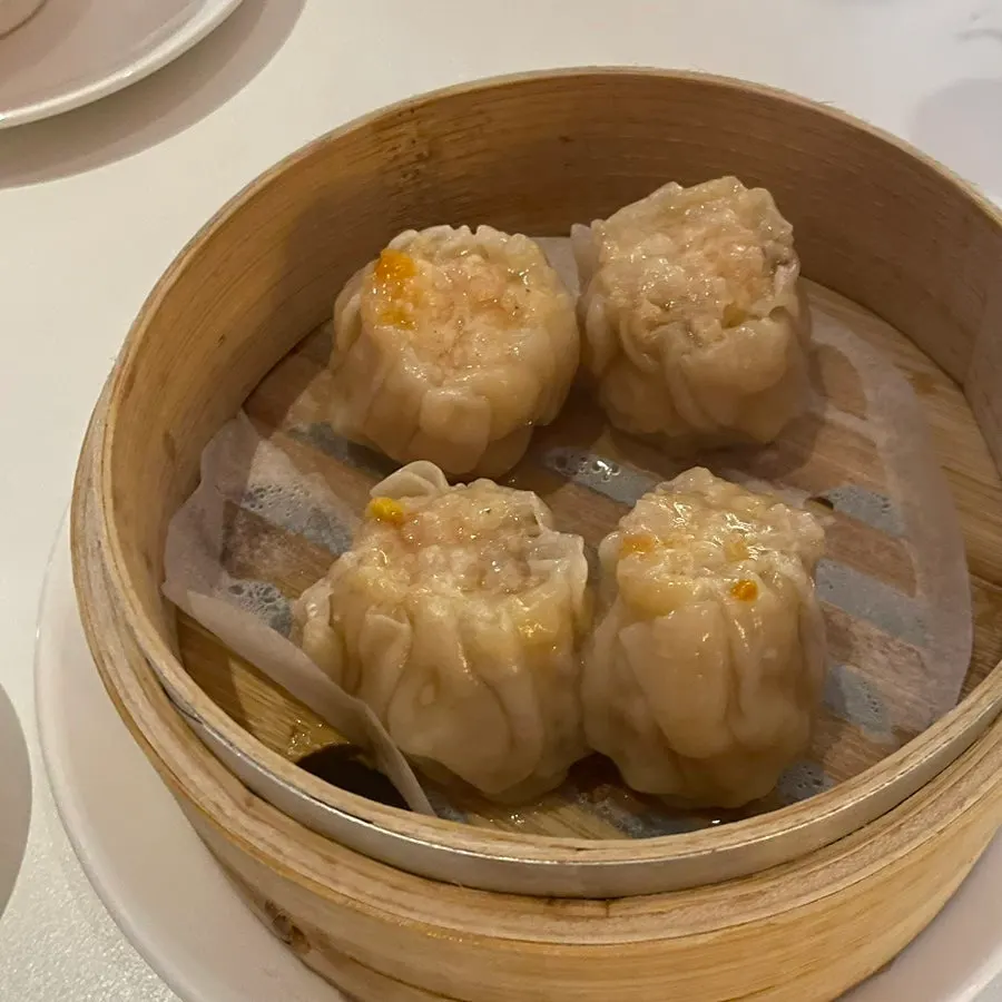 Four pieces of siu mai topped with whole shrimp