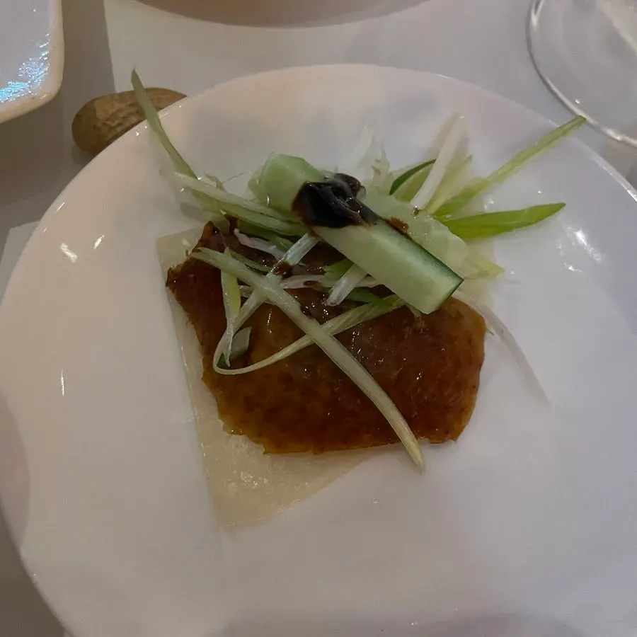 Wheat pancakes, vegetables, and sauce served with the Peking duck