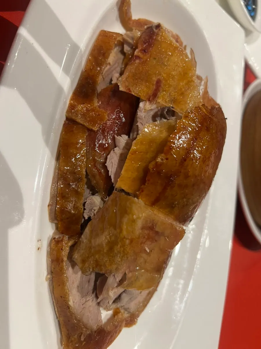 Wrapping Peking duck in a wheat pancake
