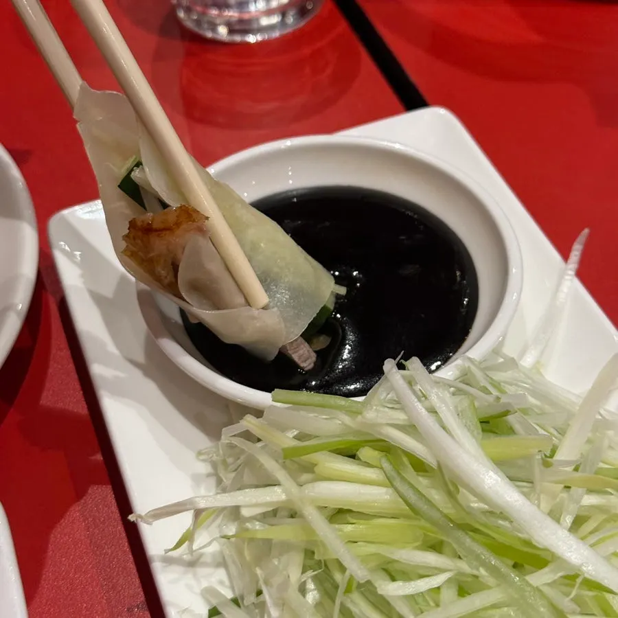 A finished Peking duck wrap ready to eat