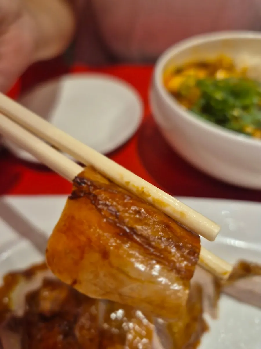 Wrapping duck meat and cucumber in a thin pancake