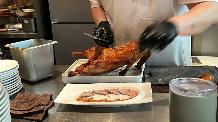 Live carving of Peking duck at the open kitchen