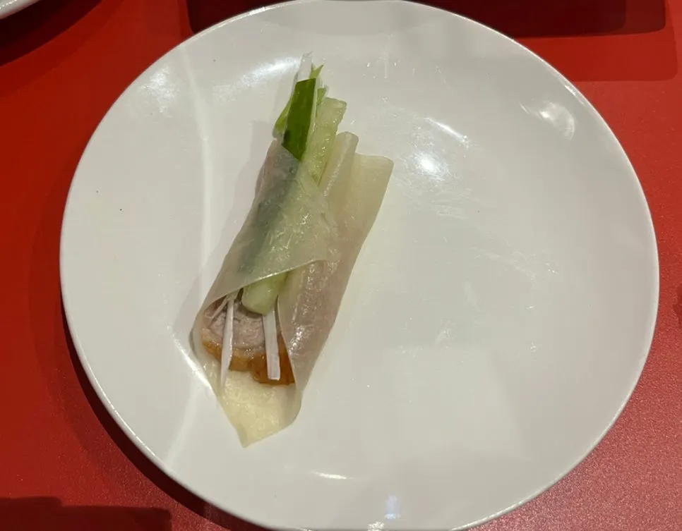 Duck skin and meat placed on top of a wheat pancake