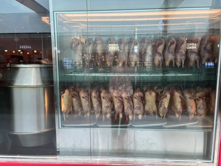 Roasted Peking ducks hanging in the corridor