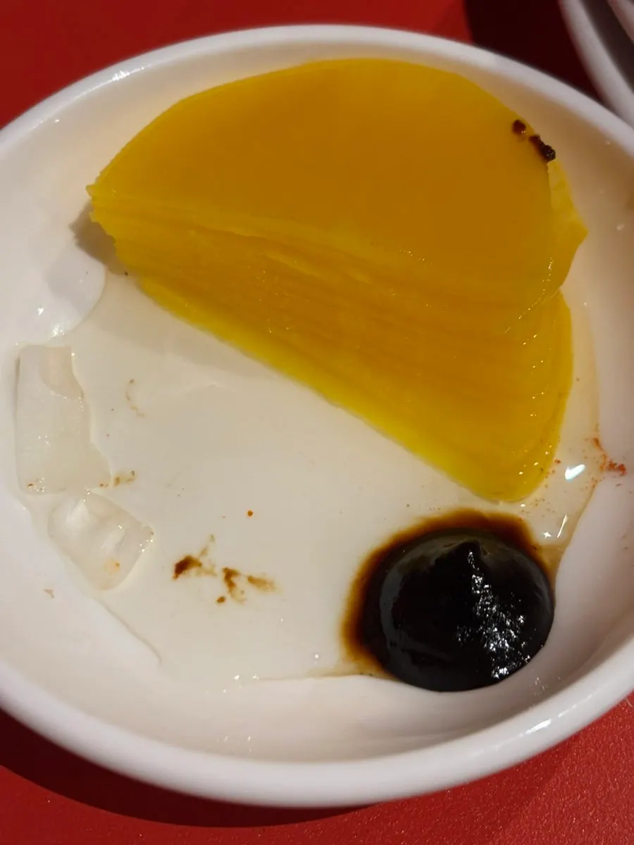 Vinegar-splashed pickled radish next to the Peking duck plate