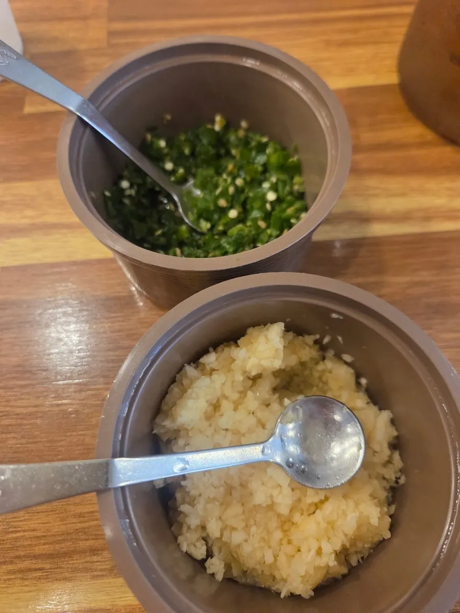 Garlic, chili pepper, and sancho powder prepared at the table