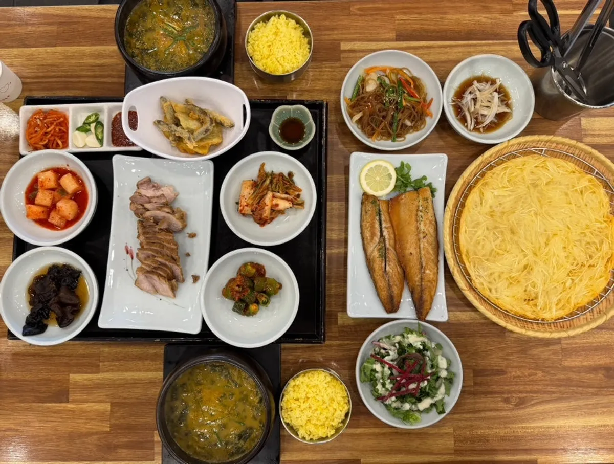 Table spread of boiled pork, grilled mackerel and loach soup set for two