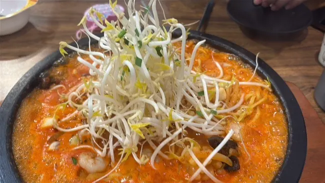 Self-serve bar with pickled radish, green onion kimchi, and rice