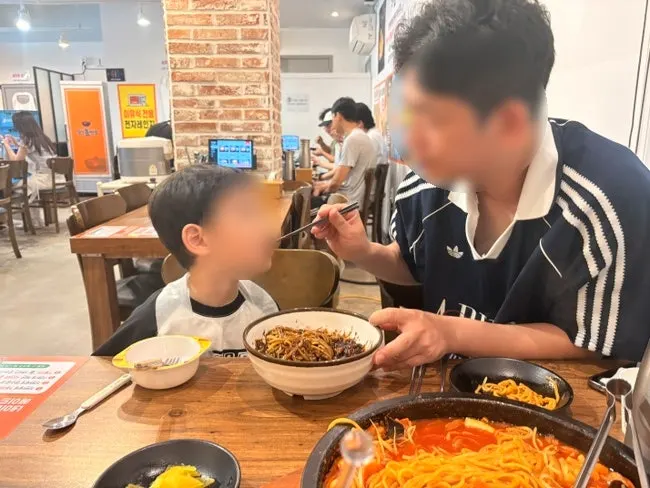 Dad and child sitting across from each other at the table