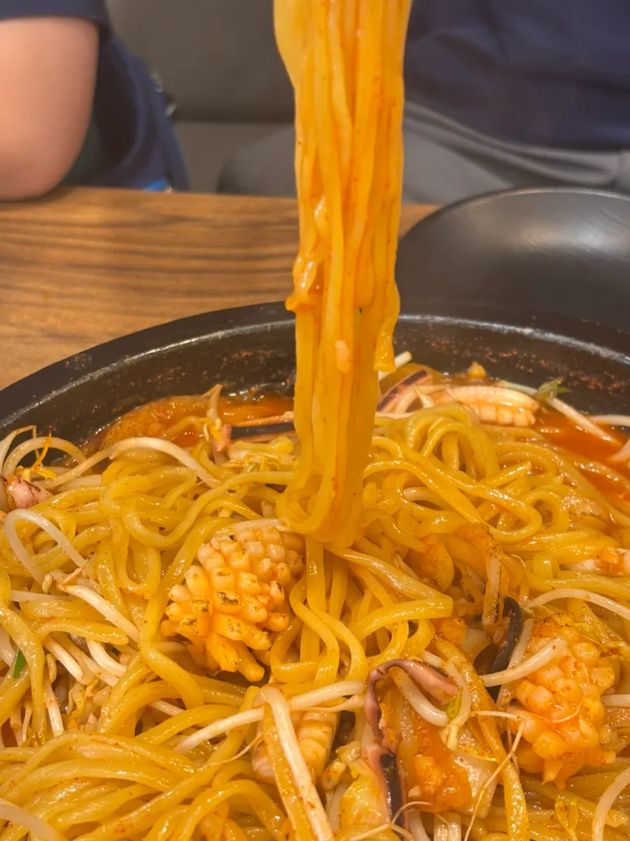 Noodles lifted up, well-coated with the stone jjamppong broth