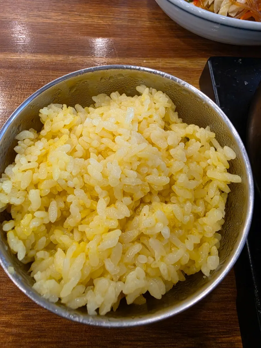 A bowl of yellow-tinged turmeric rice