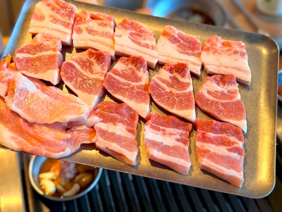 Close-up of raw pork belly with mixed fat and lean meat