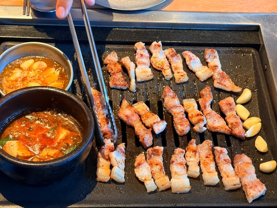 Pork belly and jowl grilling to a golden brown