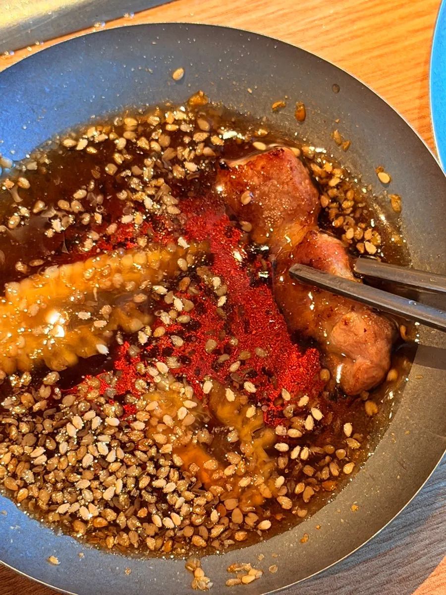 Grilled meat lifted with tongs