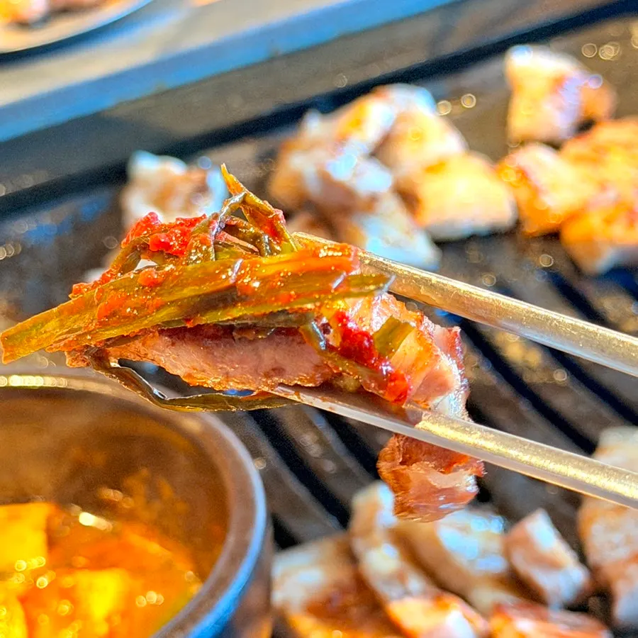 Pork belly topped with whole garlic and saeujeot