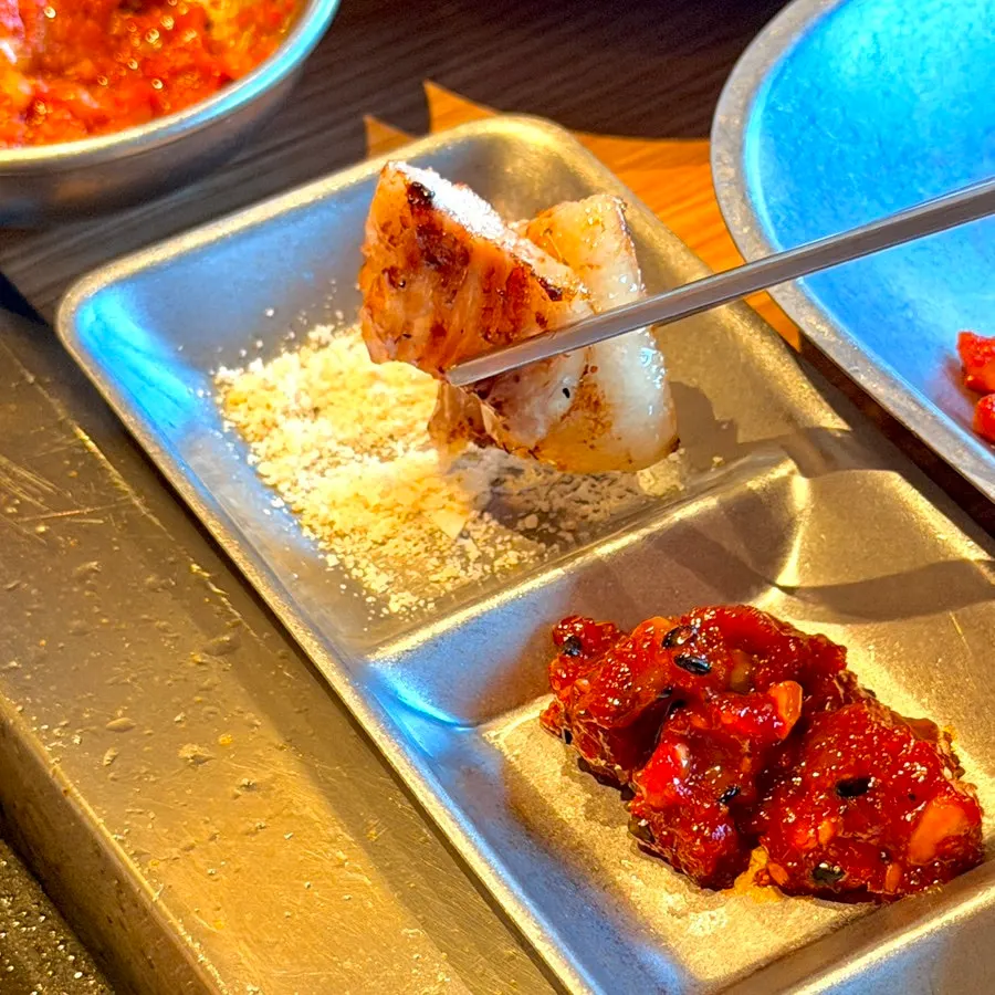 Pork jowl on the grill with side dishes