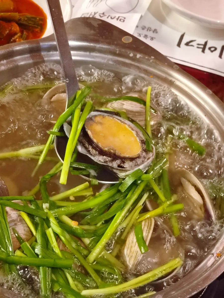 A full pot of complimentary Tongyeong abalone clam soup