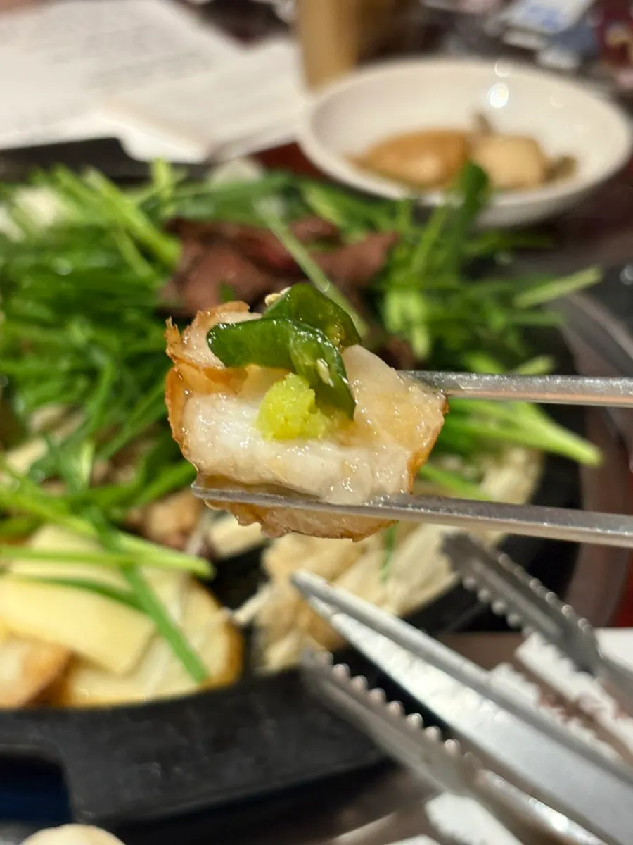A piece of beef heart dipped in wholegrain mustard sauce