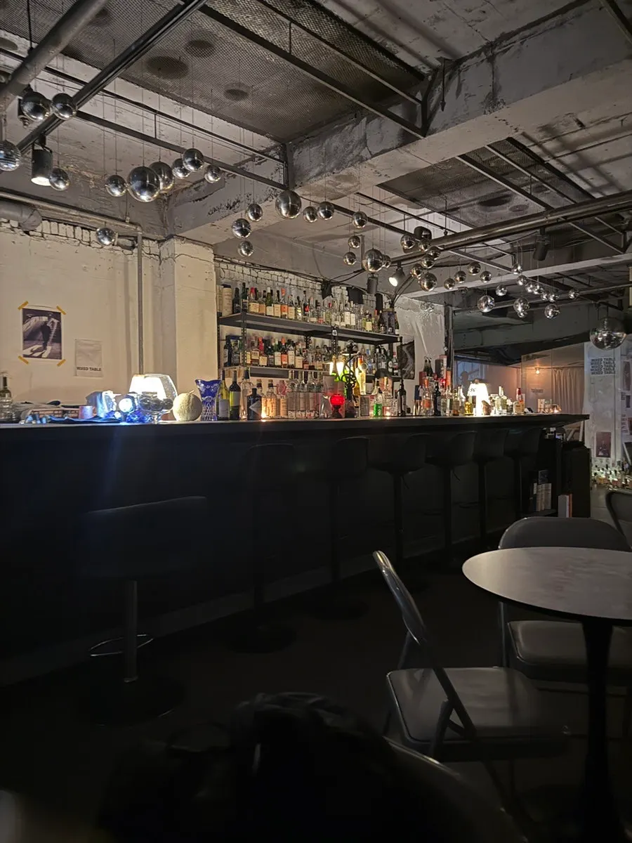 Interior with exposed concrete ceiling and soft lighting