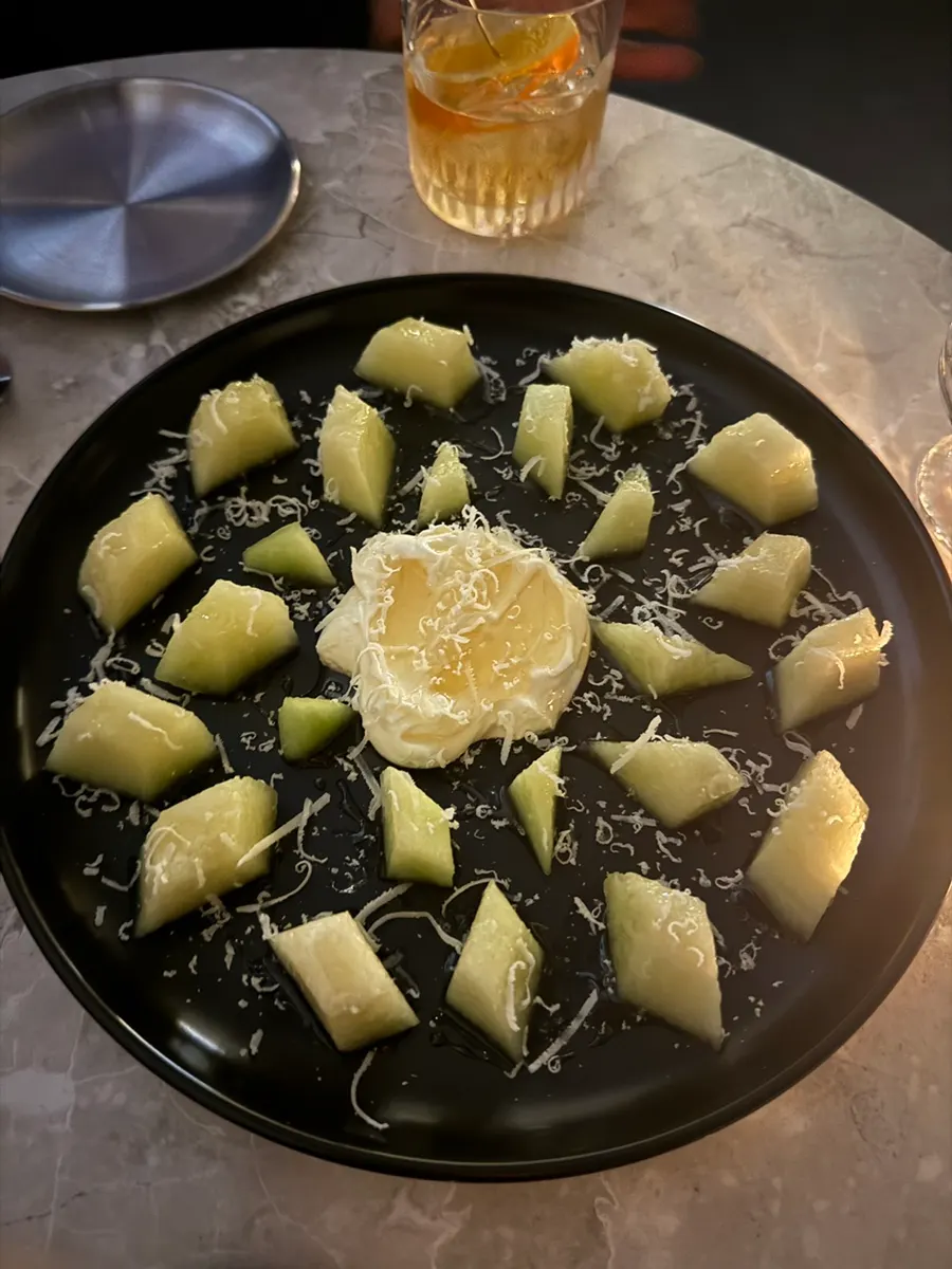 Kaymak & melon plate served on a black dish