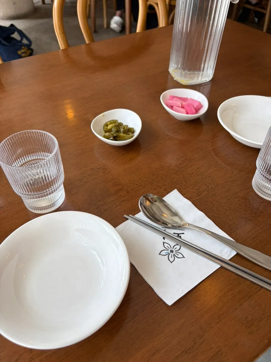 Table set with pot rice, chicken, and salad