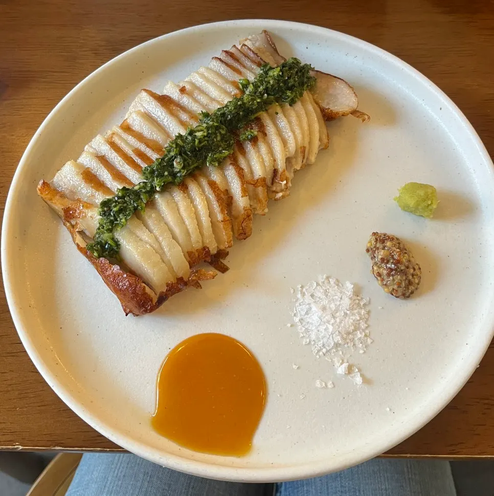 A plate of chimichurri grilled pork jowl with water parsley