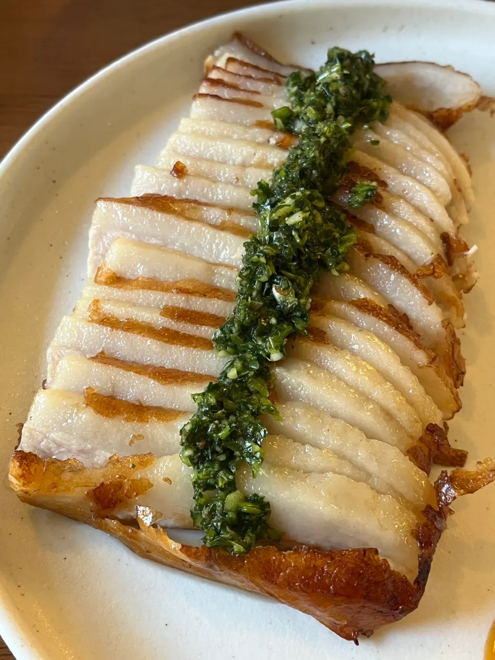 Grilled pork jowl topped with water parsley chimichurri sauce
