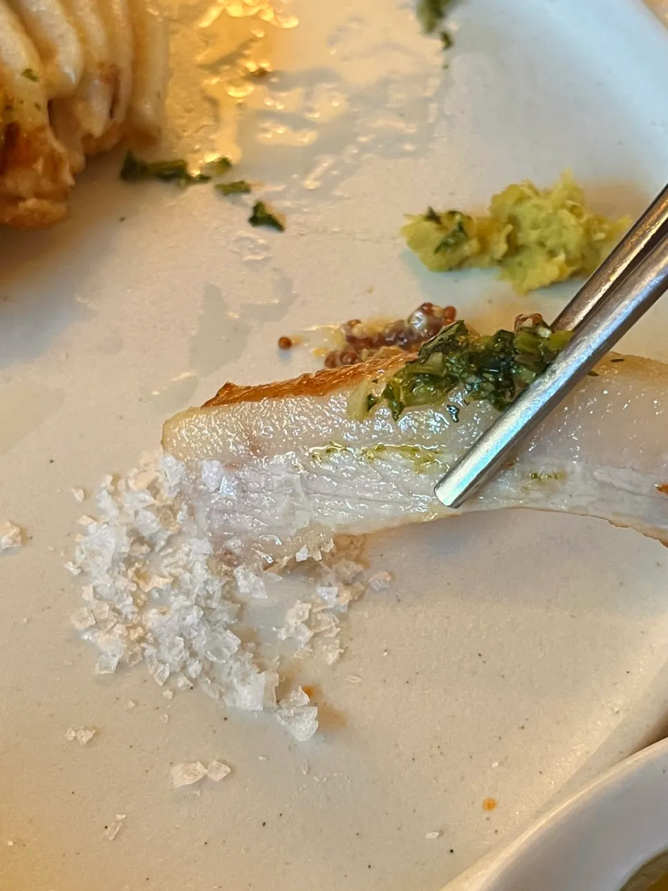A piece of pork jowl dipped in salt