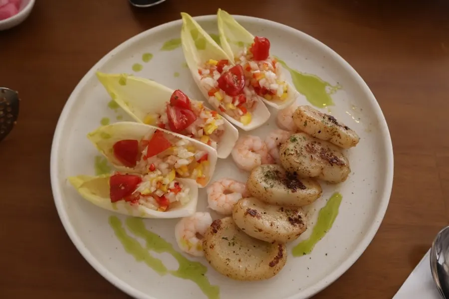 Plating of grilled scallop and endive bites